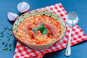 Beans stew with meat and tomato sauce.