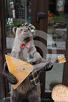 Bear with a balalaika on the Malaya Sinyukha Mountain in the Altai Mountains