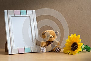 Bear doll with photo frame and sunflower.