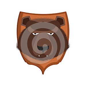 Bear hunter trophy. Grizzly head on shield. Scarecrow wild beast