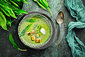 Bear leek soup or ramson soup with crouton, sour cream and turkey skewer