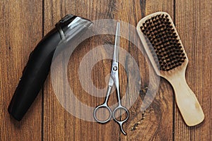 Beard grooming accessories on a luxury wooden surface.