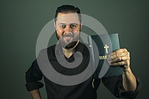 Beard man showing you a bible. The right path in life is through God