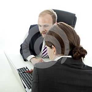 Beard man and woman at desk explain