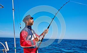 Beard sailor man fishing rod trolling in saltwater