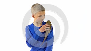 Bearded agama sitting on the shoulder of boy and he stroking her at white background. Slow motion.