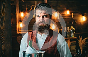 Bearded bartender or waiter in work uniform. Long bearded waiter or servant. Brutal bearded servant. Restaurant staff