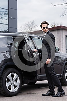 bearded bodyguard in suit and sunglasses
