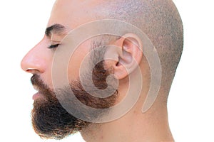 A bearded bold man with closed eyes profile portrait