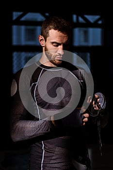 Bearded boxer readying for workout in rays of sunlight in gym