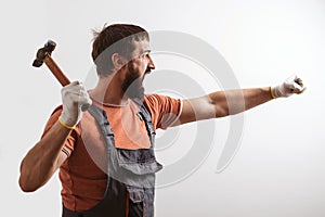 Bearded builder working with hammer. Construction work