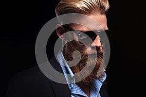 Bearded business man looks down