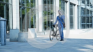 Bearded Businessman With Bike Walking On Job