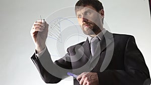 Bearded businessman draws the schedule, circuit block and diagram