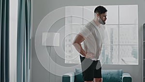 Bearded businessman practices active athletic bends warmup