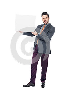 bearded businessman in suit holding blank placard,