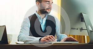 Bearded businessman working at home workplace. work in social  distance isolation. Consultant man thinking looking in monitor