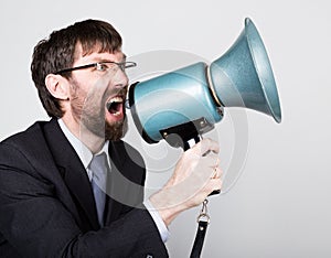 Bearded businessman yelling through bullhorn. Public Relations. man expresses various emotions. photos of young