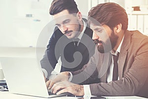Bearded businesspeople discussing project