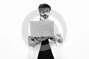 Bearded caucasian doctor or postgraduate student with laptop in mask