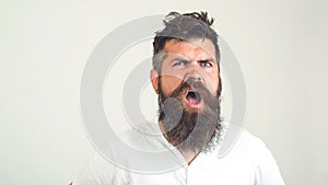 Bearded crazy man confused face. Angry man with beard with emotion, on white background. Emotion, face expression cocncept. Brutal