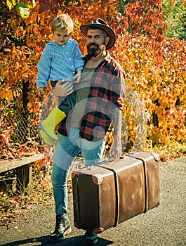 Bearded dad telling son about travelling. Traveler with lot experience. Spirit of adventurism. Father with suitcase and