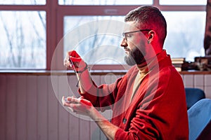 Bearded diviner wearing glasses and bracelet reading oracle cards