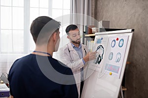 Bearded doctor showing medical case details to his colleague