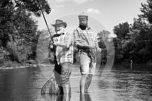 Bearded elegant men. Fisher fishing equipment. Fishing is fun. Man relaxing and fishing by lakeside. Pothunter. Fly fish
