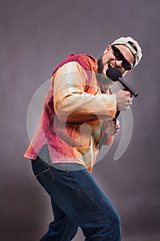 Bearded emotional rock singer with microphone studio portrait.