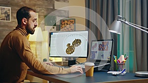 Bearded engineer in his home office at night