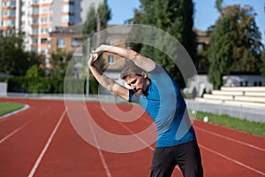 Bearded fit man warms up before training