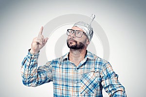 Bearded funny man in a cap of aluminum foil. Concept art phobias