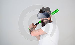 Bearded gamer with agitated look training batting skills, simulation game concept. Man with stylish beard posing with