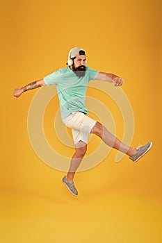 Bearded guy enjoy music. Music fan. Man listen music wireless headphones in motion. Impetuous movement. Hipster dancing