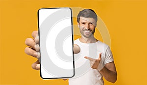 Bearded guy showing white empty smartphone screen, closeup