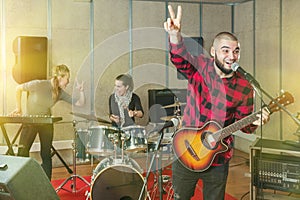 Bearded guy soloist playing guitar in studio