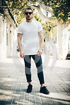 Bearded guy wearing white blank t-shirt and blue