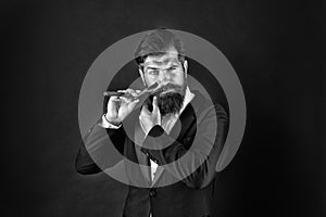 Bearded and hairy. Bearded man hold razor dark background. Businessman with bearded face. Unshaven hipster shave facial