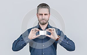 bearded handsome mature man businessman demonstrating business card with copy space, advert