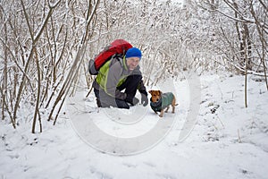 Bearded hiker man is talking to his dog