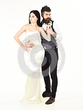 Bearded hipster with attractive bride dressed up for wedding ceremony. Couple in love, bride and groom in elegant
