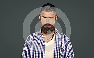 bearded hipster man wear checkered shirt on grey background