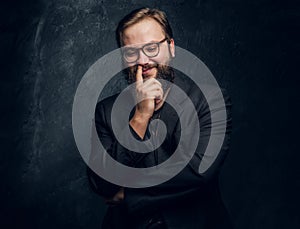 Bearded hipster picks his nose