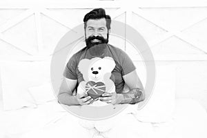 Bearded hipster prepare lovely gift. Valentines day gift. Spread love. Present for sweetheart. Man hug soft toy relaxing