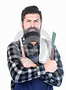 Bearded hipster wear apron for barbecue. Roasting and grilling food. Man hold cooking utensils barbecue. Tools for