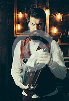 Bearded hipster wear waistcoat.Brutal bearded servant. Hipster barman in waistcoat and gloves. Barman. Waiter is wearing