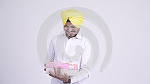 Bearded Indian Sikh businessman opening empty gift box