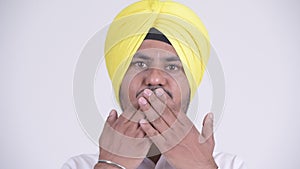 Bearded Indian Sikh businessman showing speak no evil concept