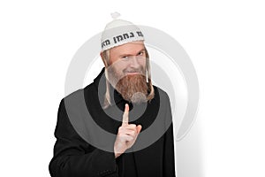 Bearded jewish man with sidelocks in white kippah hinting do not try to deceive me. Sly jew showing warning with finger